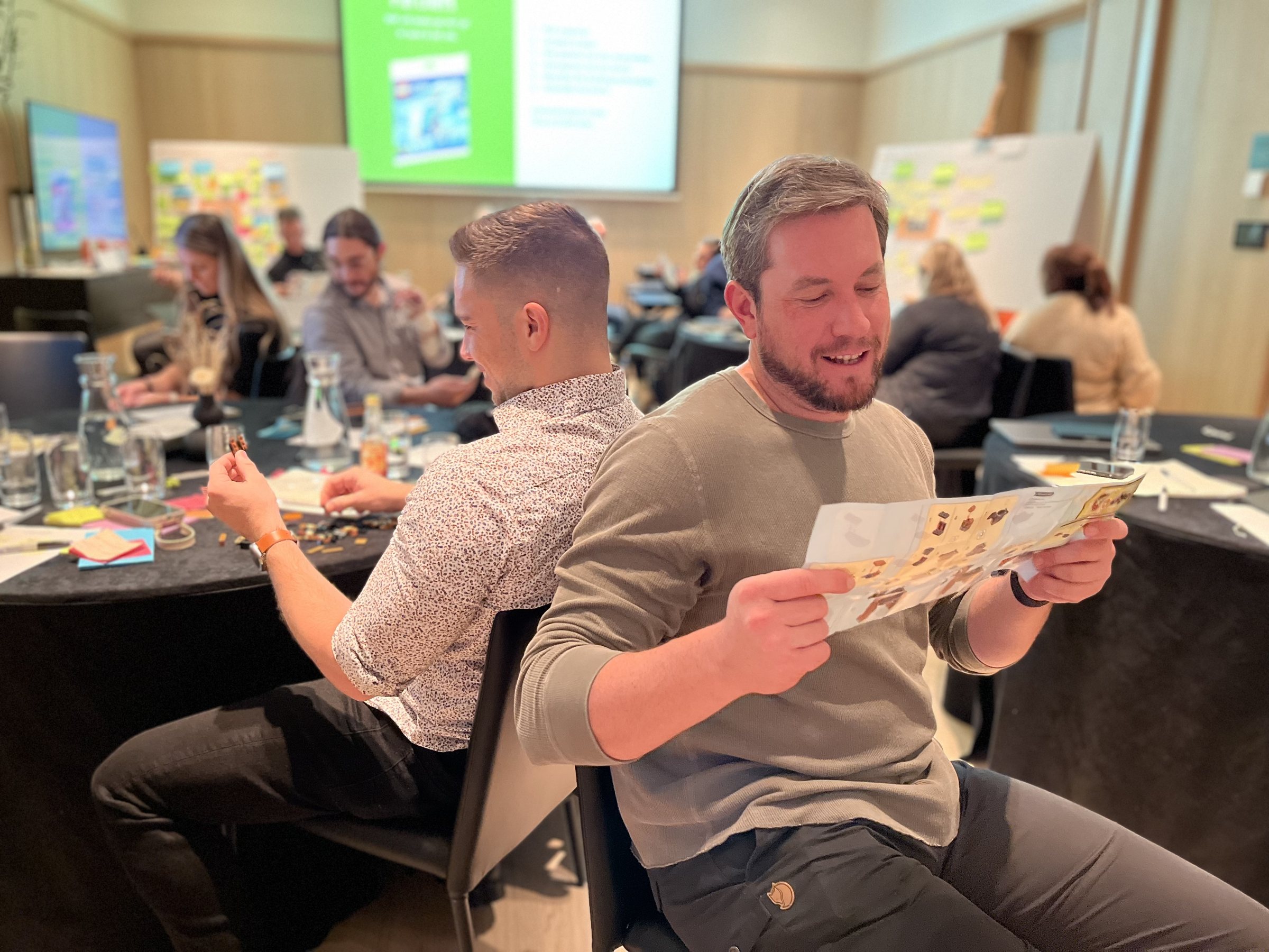 Two peers sharing a laugh during a hands-on session