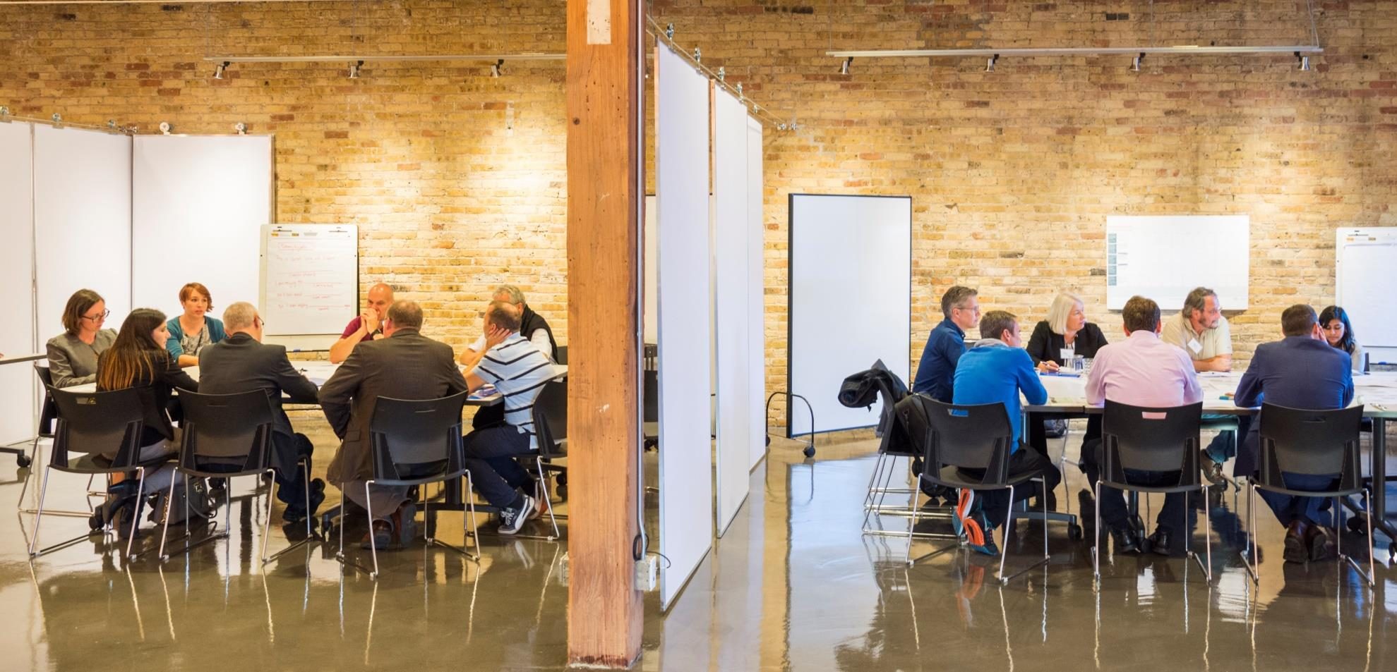 A peergroup gathering in a loft space, leaders working together